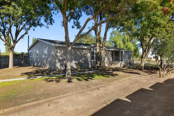 a view of a house with yard and tree s