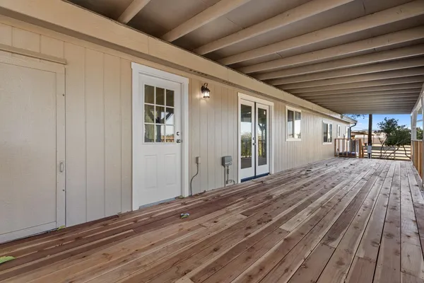 a view of a balcony with wooden floor