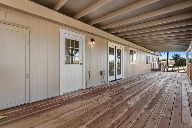 a view of a balcony with wooden floor