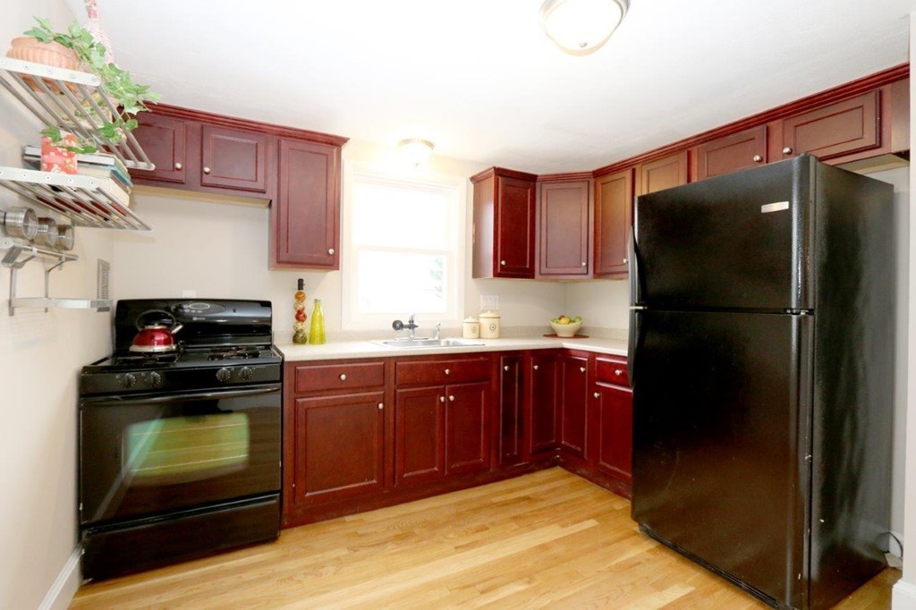 46-48 Raldne Road, Unit 48 Boston, MA 02136 - Photo 3 of 13 a kitchen with a refrigerator stove and cabinets