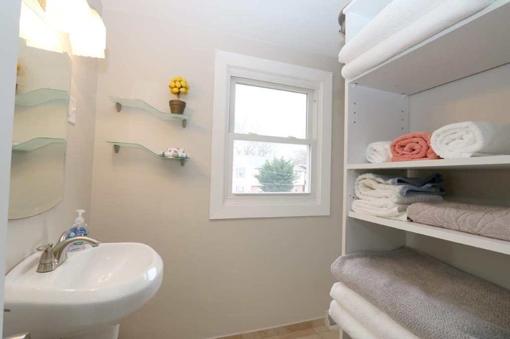 46-48 Raldne Road, Unit 48 Boston, MA 02136 - Photo 9 of 13 a en suite bathroom with a granite countertop sink and a mirror