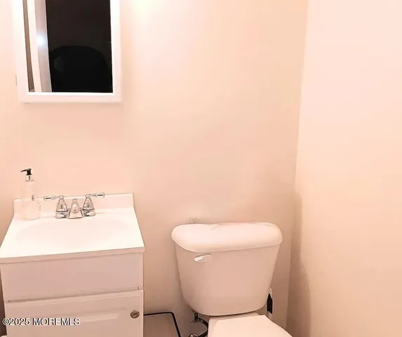 a toilet sitting in a bathroom next to a sink