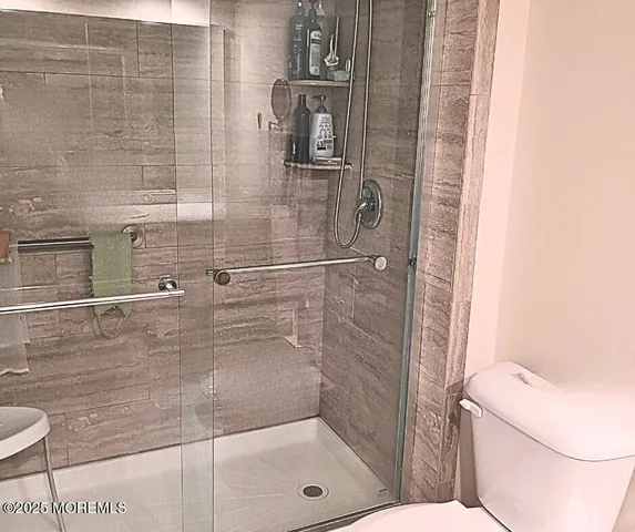 a bathroom with a toilet and shower