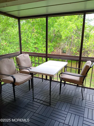 a view of a chairs and table in the roof deck