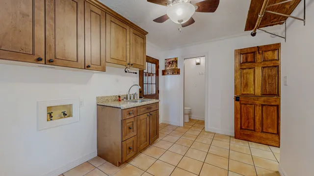 a kitchen with stainless steel appliances granite countertop a refrigerator a stove and a sink with dishwasher