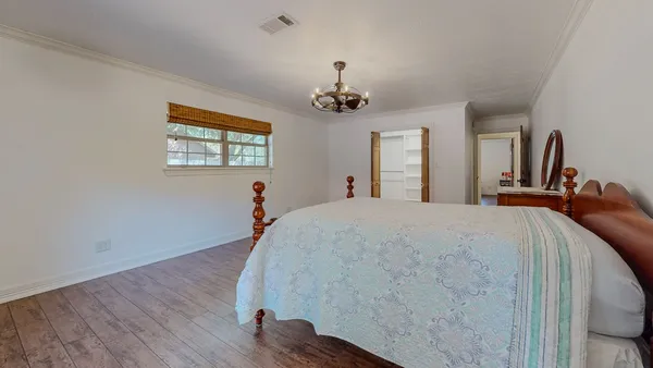 a bed room with a bed and a chandelier