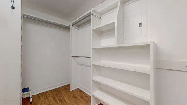 a view of walk in closet with empty racks