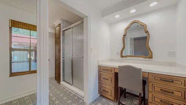 a bathroom with a sink a mirror and a window