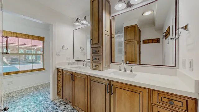 a bathroom with a double vanity sink and a mirror