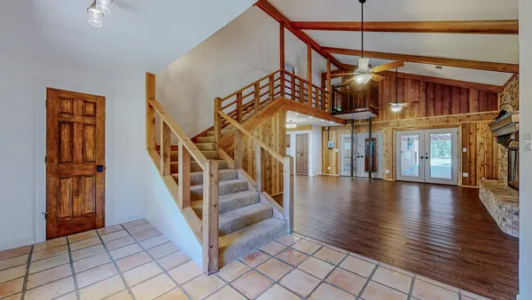 a view of entryway and hall with wooden floor