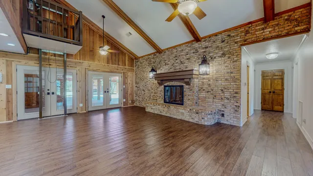 a view of a porch with wooden floor and a fireplace