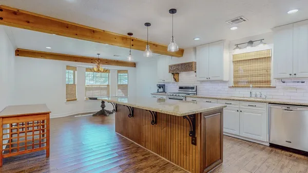 a kitchen with a sink and wooden floor