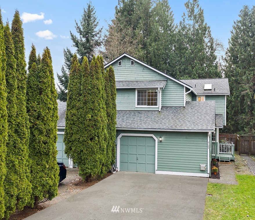2122 186th Place Southeast Bothell, WA 98012 - Photo 1 of 25 a front view of a house with yard and trees