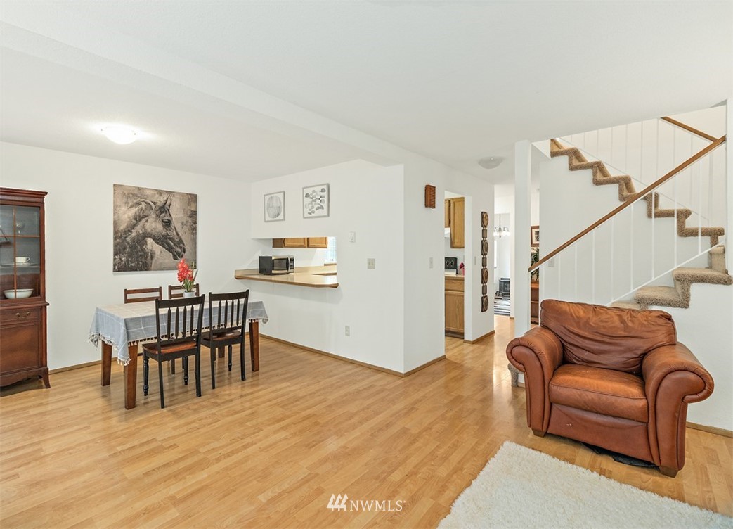 2122 186th Place Southeast Bothell, WA 98012 - Photo 12 of 25 a living room with furniture and a dining table with wooden floor