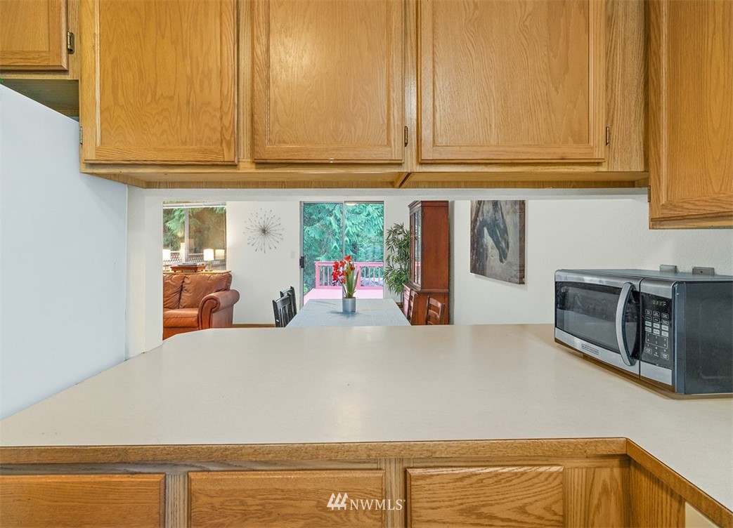 2122 186th Place Southeast Bothell, WA 98012 - Photo 18 of 25 a kitchen with stainless steel appliances granite countertop a refrigerator and stove top oven