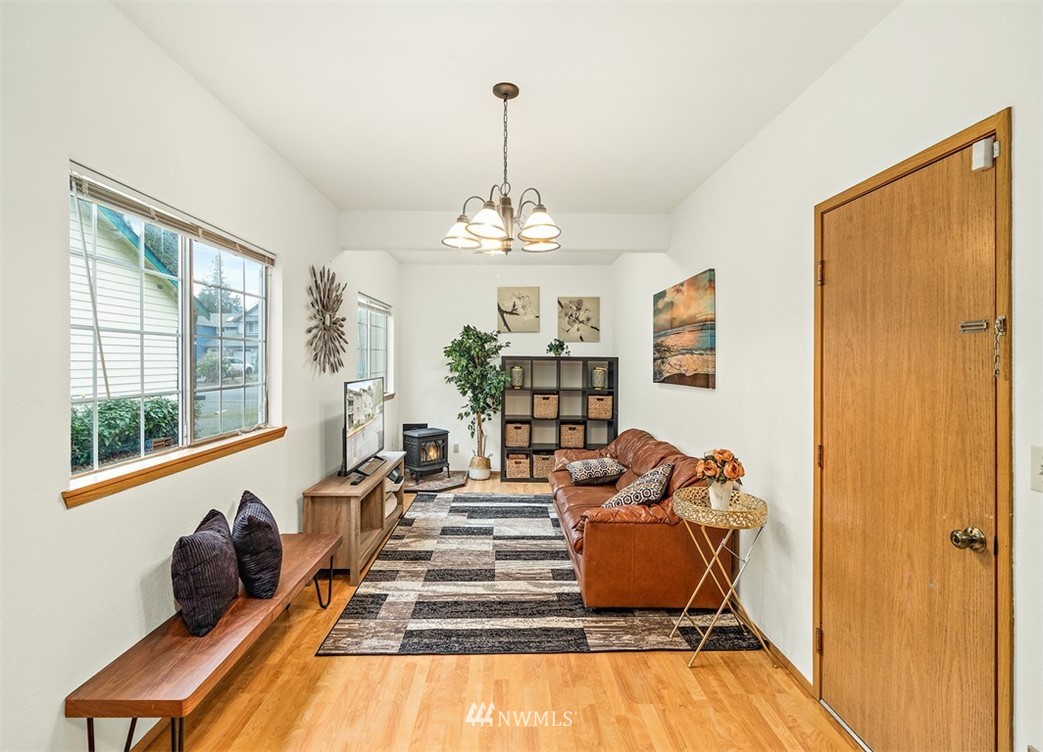 2122 186th Place Southeast Bothell, WA 98012 - Photo 7 of 25 a living room with furniture windows and a chandelier