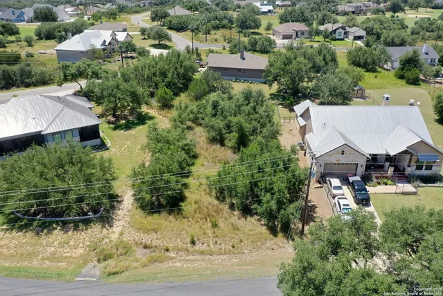 an aerial view of a house with a yard basket ball court and outdoor seating
