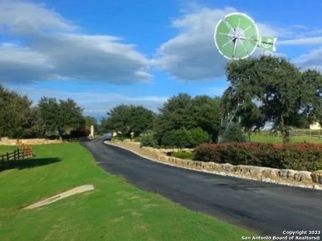 a view of a play ground with large trees