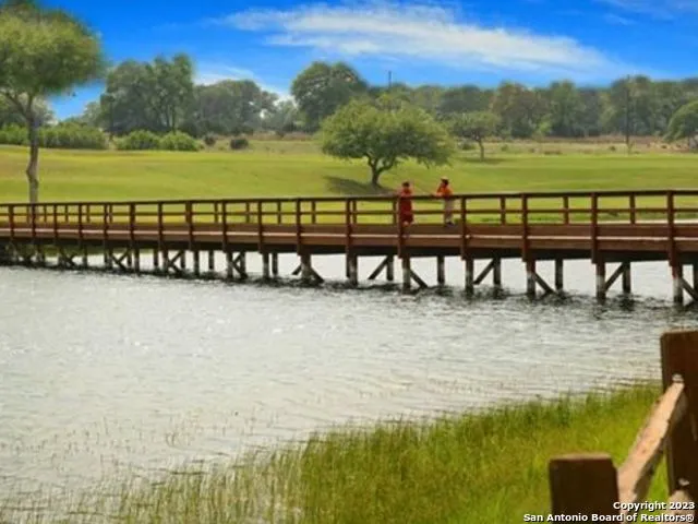 a view of swimming pool with lake and mountain view