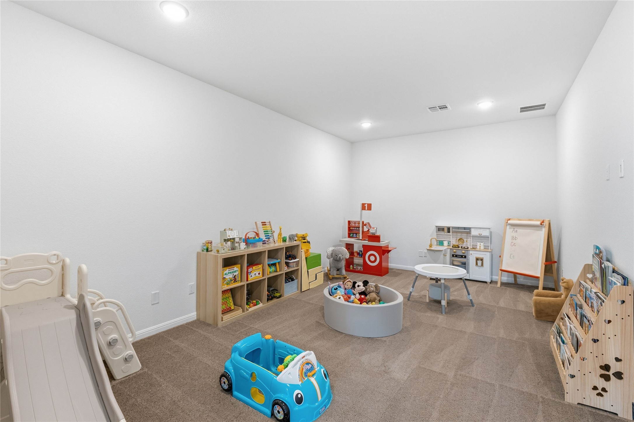 836 Villa Rialto View Leander, TX 78641 - Photo 27 of 33 A dedicated play space provides ample room for imagination to flourish.