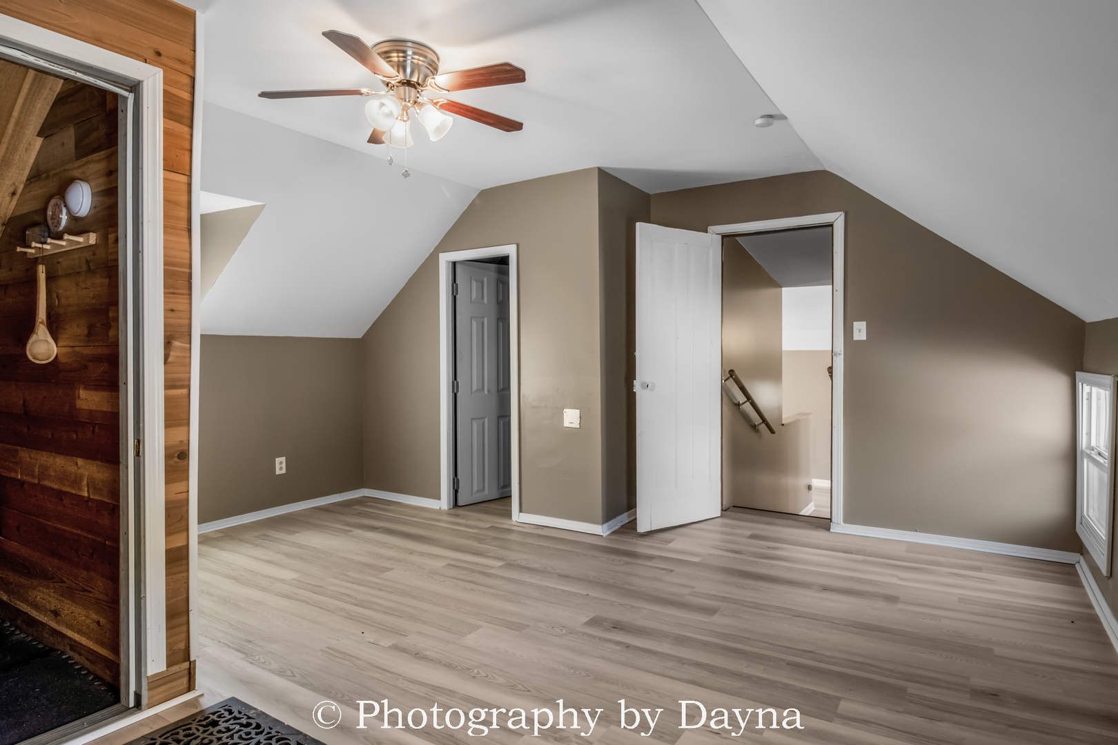 569 South Chestnut Street Chebanse, IL 60922 - Photo 16 of 22 a view of a big room with wooden floor and a ceiling fan