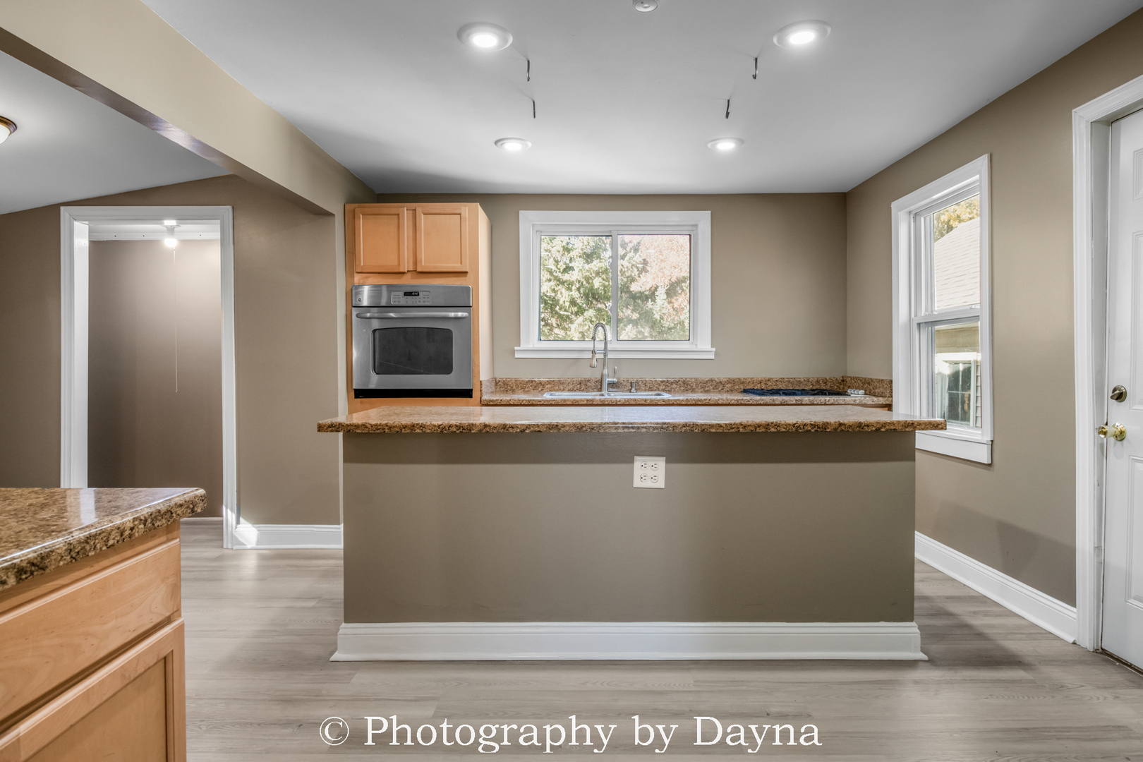 569 South Chestnut Street Chebanse, IL 60922 - Photo 3 of 22 a living room with stainless steel appliances kitchen island granite countertop a refrigerator a stove and a sink with large window