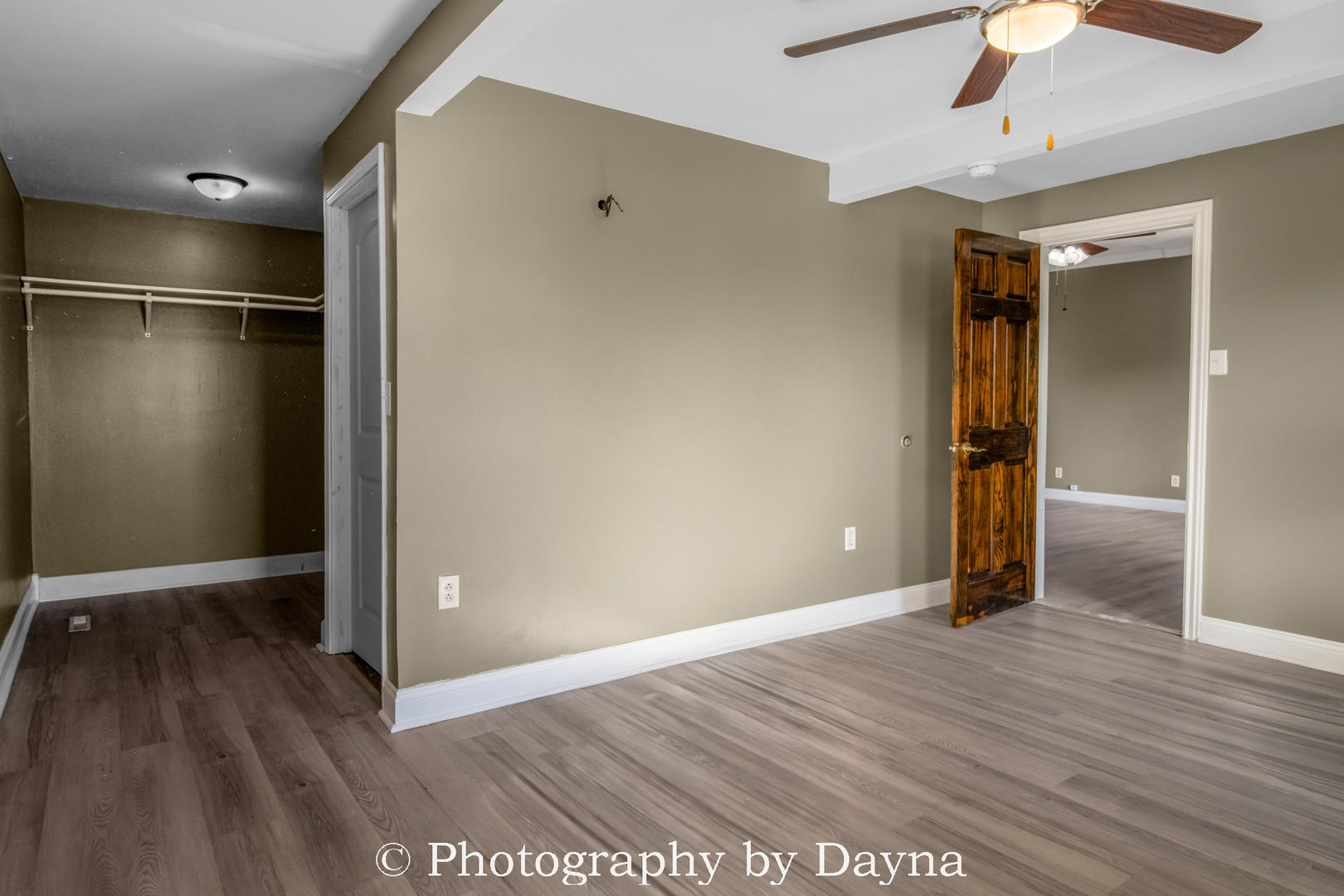569 South Chestnut Street Chebanse, IL 60922 - Photo 9 of 22 an empty room with wooden floor and way to kitchen