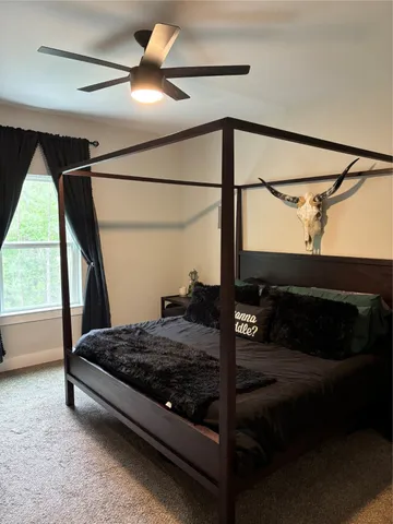 a bedroom with a bed and a window