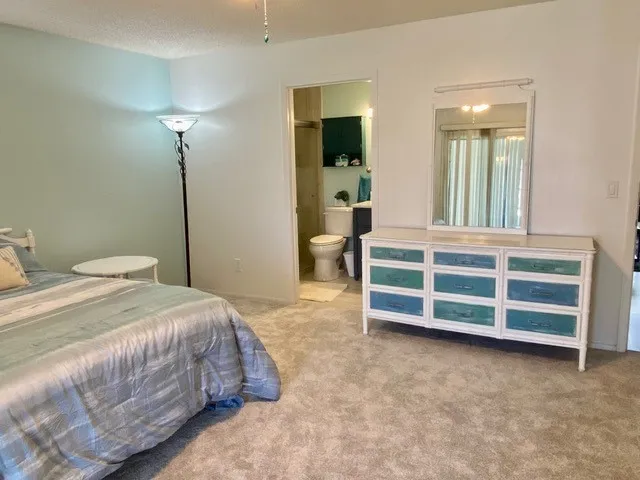 a bedroom with a bed and a view of bathroom