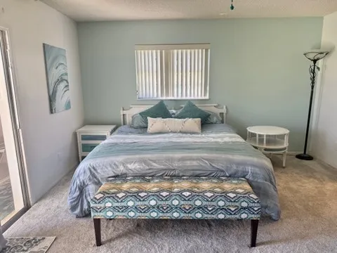 a bedroom with a bed and window