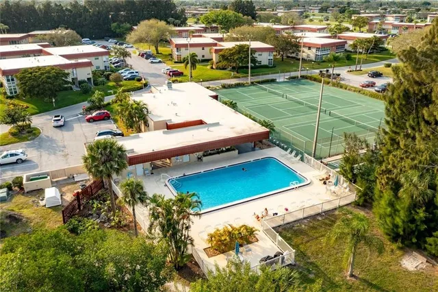 an aerial view of a house with a yard and lake view