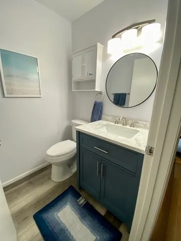 a bathroom with a toilet sink and mirror
