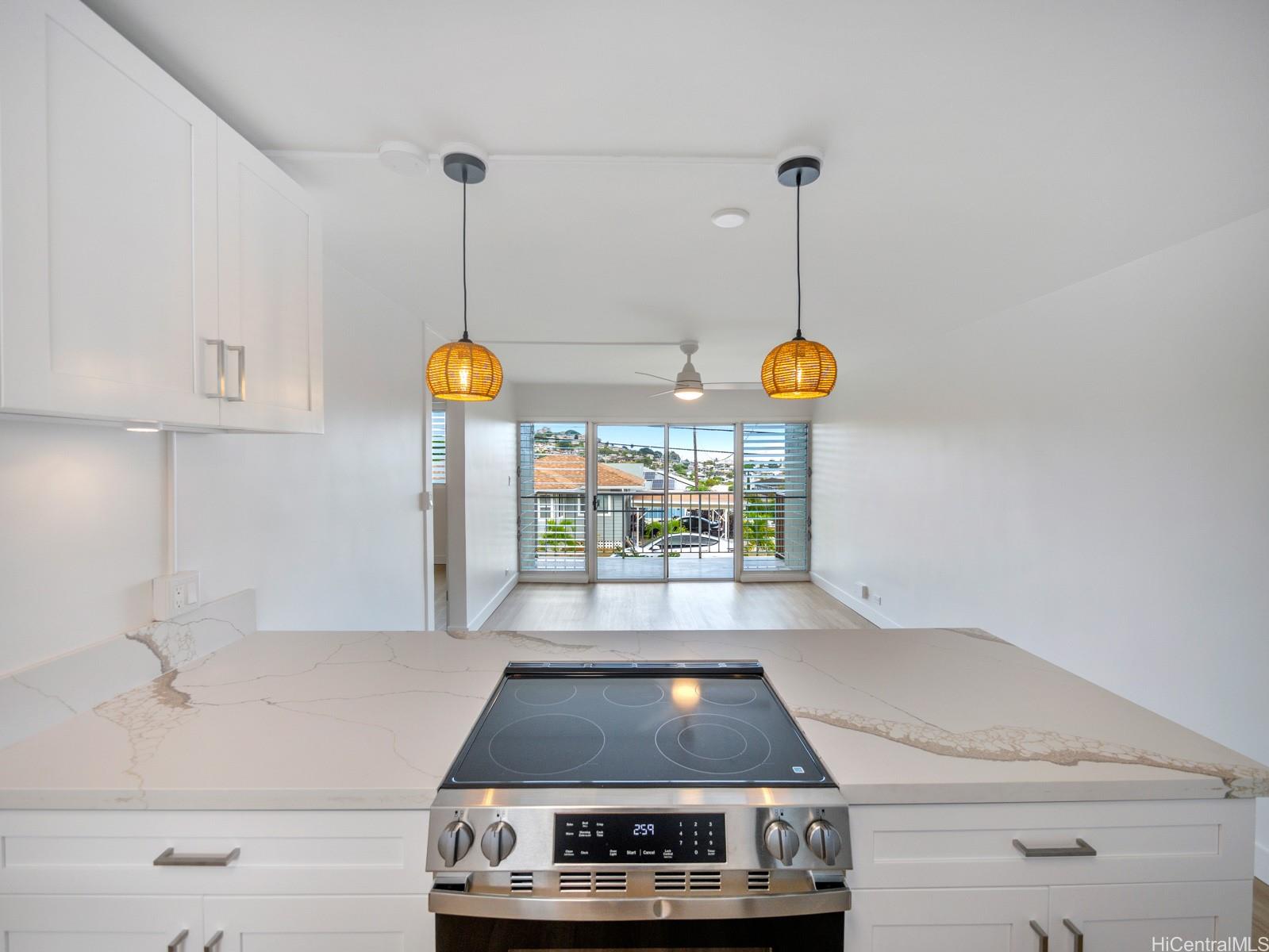 45-342 Lilipuna Road, Unit 204 Kaneohe, HI 96744 - Photo 11 of 25 a kitchen with a stove and cabinets