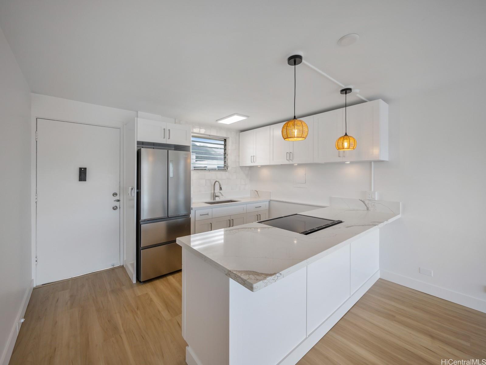 45-342 Lilipuna Road, Unit 204 Kaneohe, HI 96744 - Photo 12 of 25 a kitchen with stainless steel appliances granite countertop a sink and a refrigerator