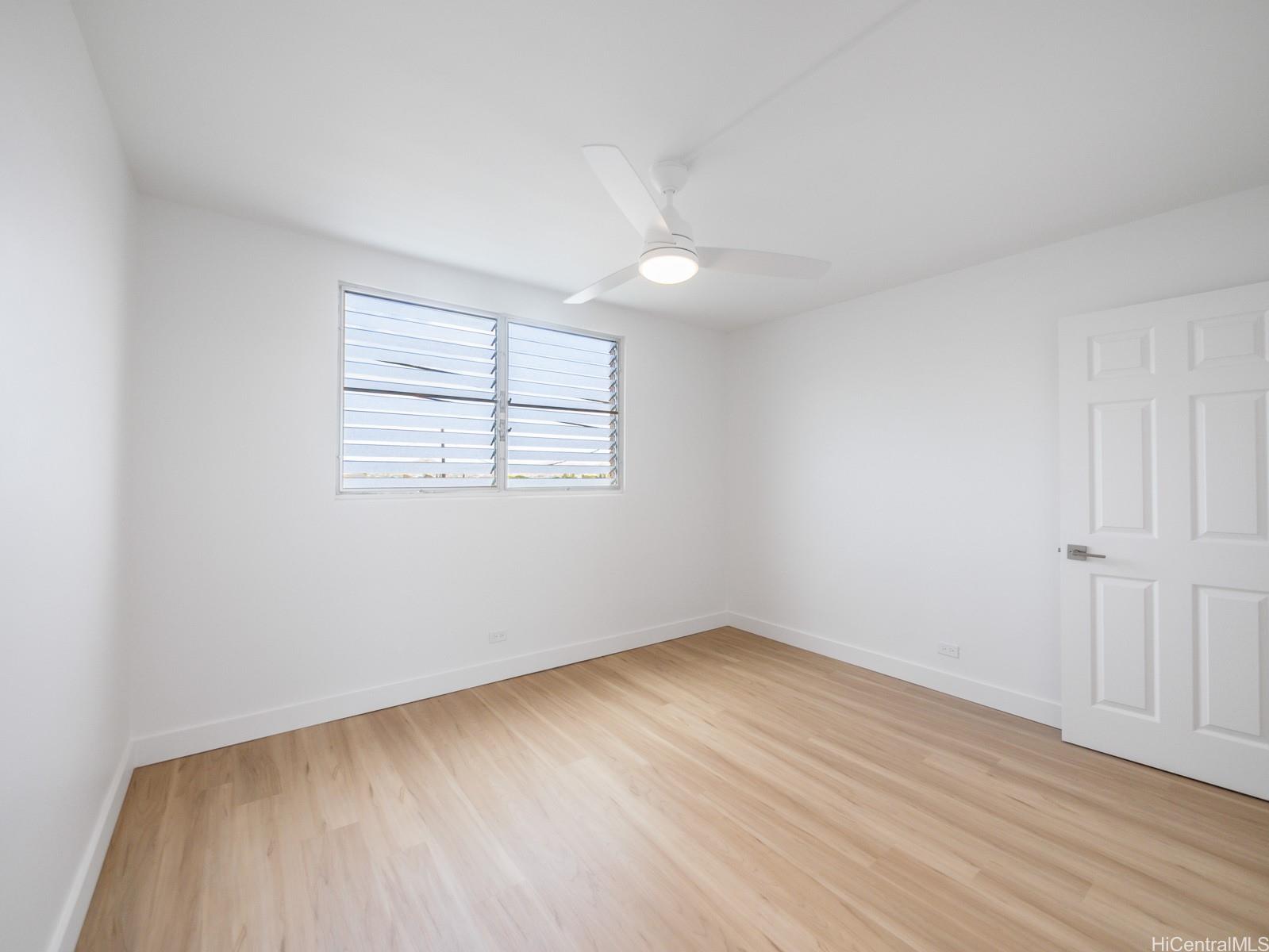 45-342 Lilipuna Road, Unit 204 Kaneohe, HI 96744 - Photo 20 of 25 an empty room with wooden floor and windows