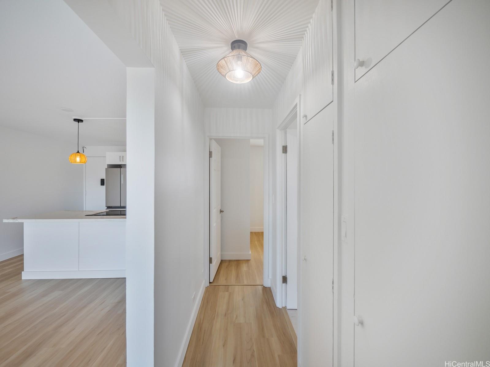 45-342 Lilipuna Road, Unit 204 Kaneohe, HI 96744 - Photo 22 of 25 a view of a hallway with wooden floor