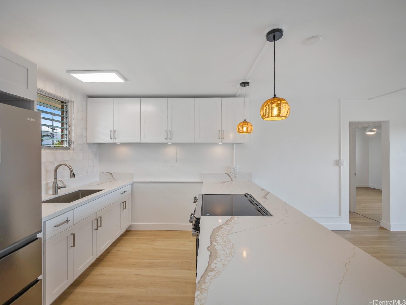 45-342 Lilipuna Road, Unit 204 Kaneohe, HI 96744 - Photo 5 of 25 a kitchen with cabinets and window