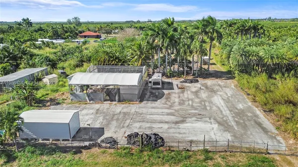 an aerial view of a house with yard swimming pool and outdoor seating