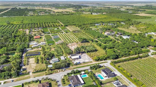 an aerial view of a residential houses with outdoor space