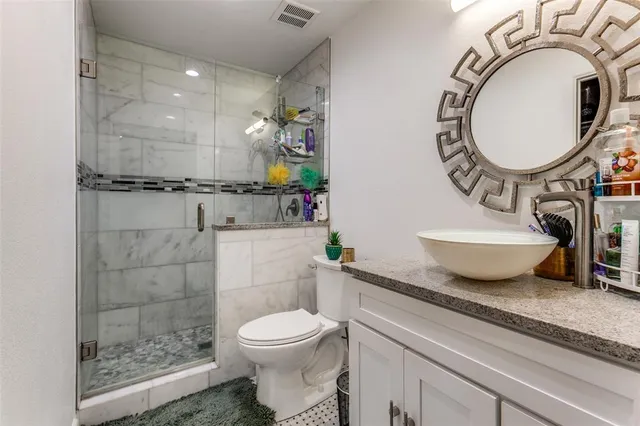 a bathroom with a toilet a sink and a mirror