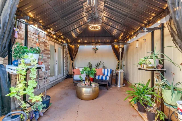 a view of a porch with dining table and chairs