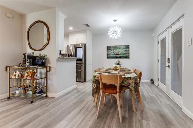 a view of a dining room with furniture and chandelier