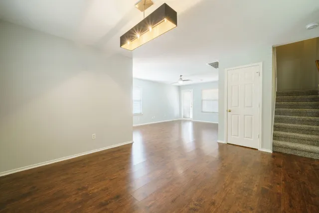 a view of wooden floor and windows in a room
