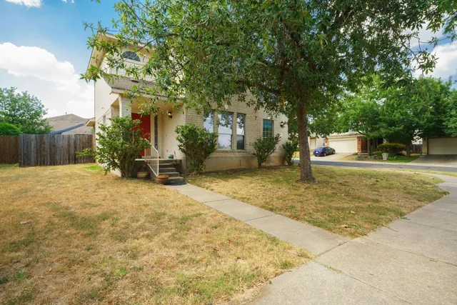 a backyard of a house with yard and trampoline