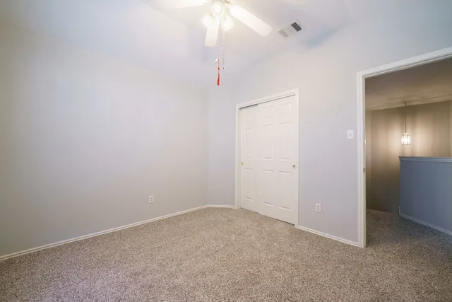 an empty room with a fan
