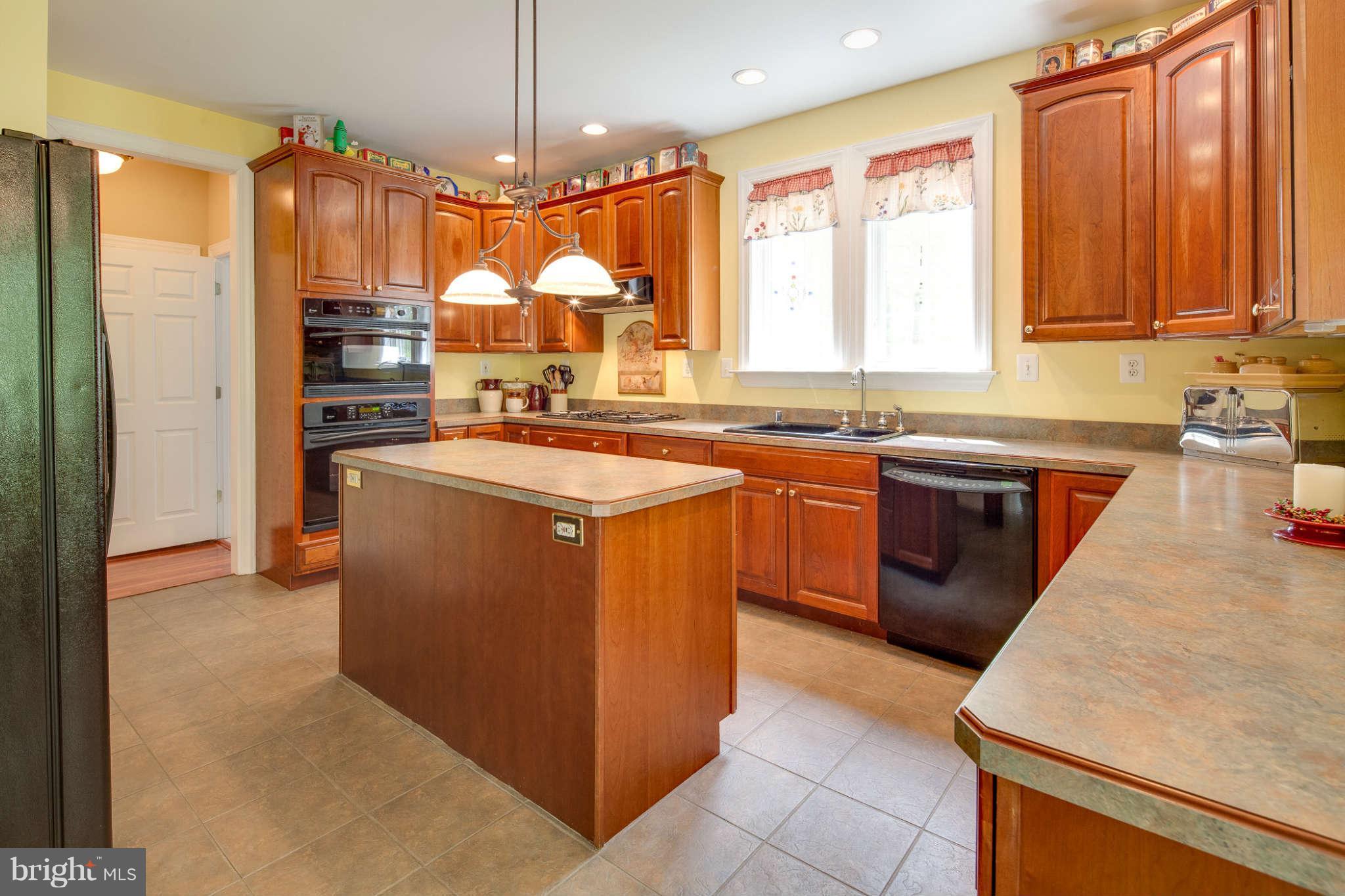 3011 Belford Road Finksburg, MD 21048 - Photo 7 of 30 a kitchen with stainless steel appliances granite countertop a sink a stove and a refrigerator