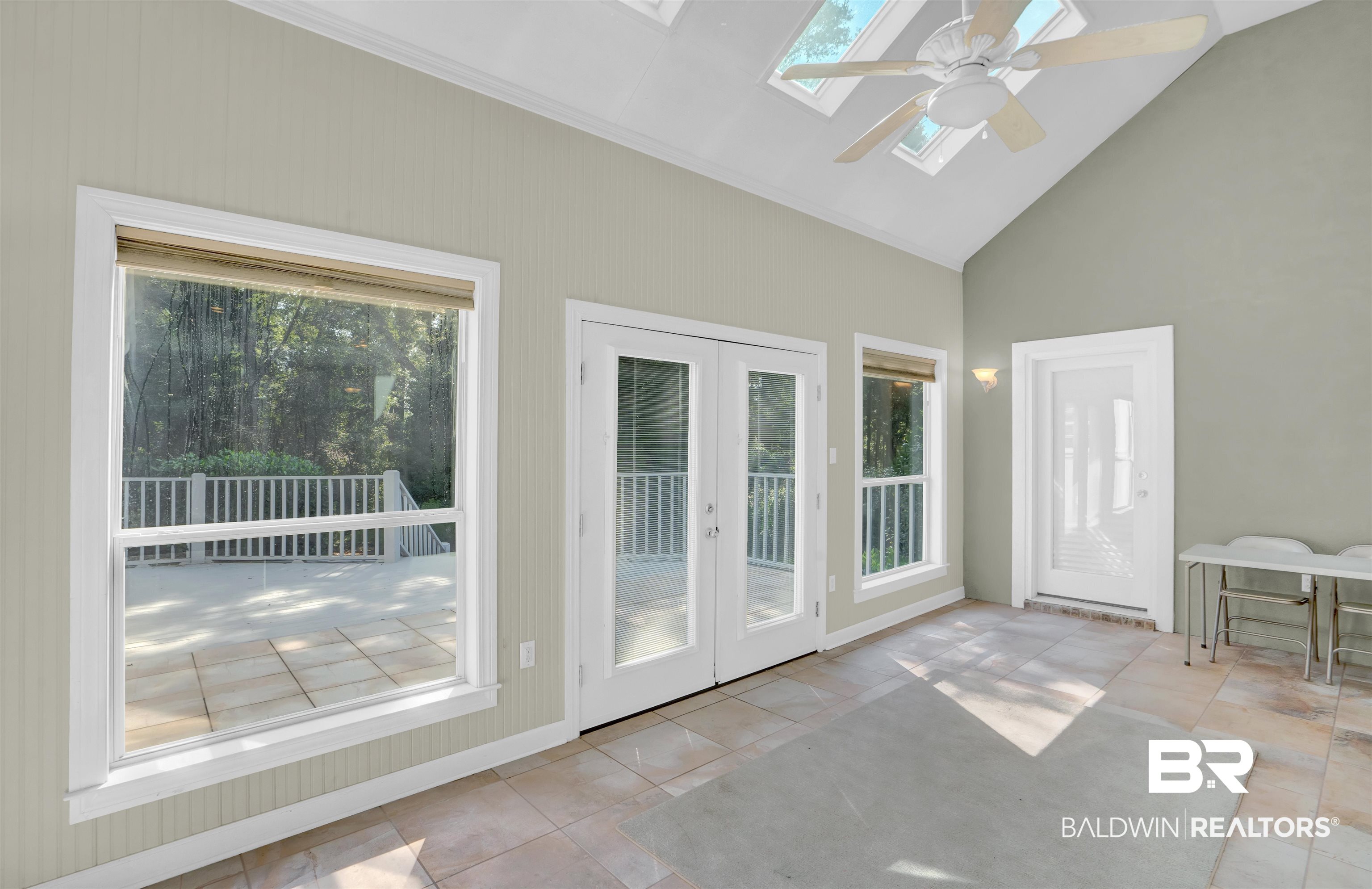 111 Beaver Dam Road Fairhope, AL 36532 - Photo 24 of 51 Unfurnished sunroom featuring vaulted ceiling with skylight, ceiling fan, and french doors