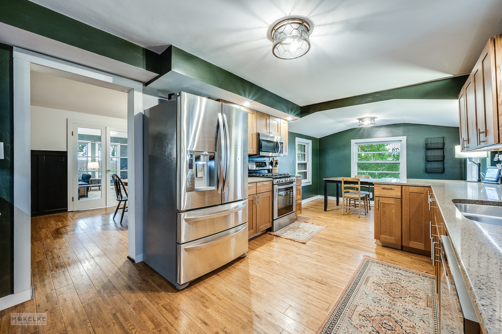 3494 Howlett Road Paw Paw, IL 61353 - Photo 10 of 47 a kitchen with stainless steel appliances granite countertop a refrigerator a stove oven and couches with wooden floor