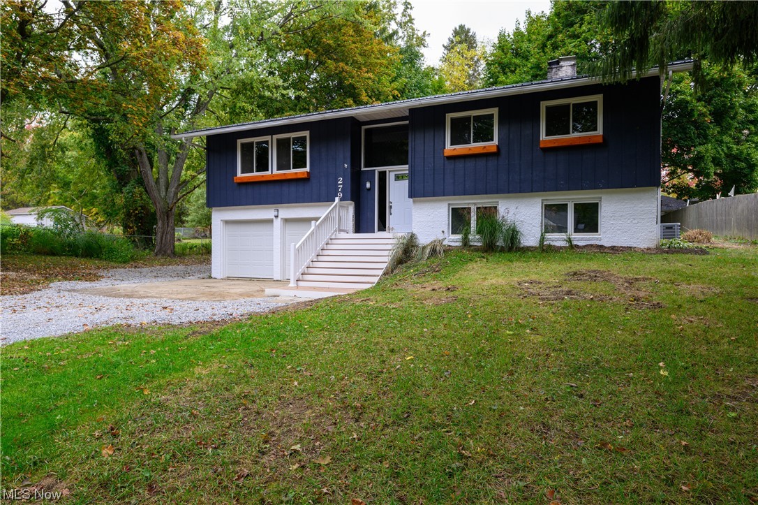 279 South Messner Road New Franklin, OH 44319 - Photo 2 of 30 Bi-level home featuring a garage, a front yard, and central AC unit