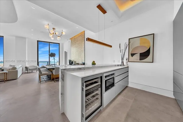 a kitchen with stainless steel appliances a sink and a refrigerator